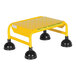 A yellow Vestil rolling step ladder with black wheels.