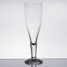 A Stolzle stemmed pilsner glass on a table with a white background.