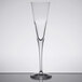 A Stolzle flute wine glass with a long stem on a table.
