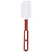 A close-up of a white Vollrath High Heat Silicone Spatula with a red handle.