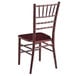 A Lancaster Table & Seating mahogany wood Chiavari chair with a wooden seat and dark finish.