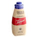 A bottle of Torani Sugar-Free White Chocolate Flavoring Sauce with a blue lid.