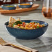 A bowl of food on a table.