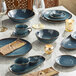 A table set with blue Acopa Highlands bowls.