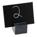 An American Metalcraft black marble card holder with a white card in it.
