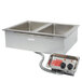 An APW Wyott stainless steel drop-in hot food well with two pans and knobs on a counter.
