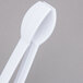 A pair of white plastic Fineline tongs.