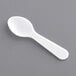 A white plastic Choice tasting spoon on a gray surface.