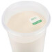 A plastic container with a white substance in it and a green and white Noble Products label.