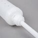 A white plastic tube with a long white plastic rod.