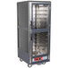 A gray Metro C5 heated holding cabinet with shelves and clear dutch doors.