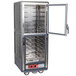 A gray Metro C5 heated holding cabinet with clear Dutch doors open.