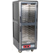 A large grey Metro C5 heated holding cabinet with clear glass doors.