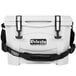 A white Grizzly cooler with black straps and a handle.