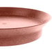 A close up of a round metal pan with a brown rim.