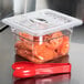A Cambro clear plastic FlipLid on a food container with food inside.