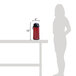 A woman uses a red Curtis ThermoPro airpot on a table outdoors.