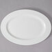 A 10 Strawberry Street white porcelain oval platter on a gray surface.