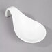 A white porcelain tapas spoon with a curved handle.
