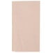 A white rectangular Just1 Interfold Kraft napkin with black lines on a pink surface.