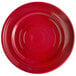 A red Tuxton Concentrix china plate with a spiral pattern.