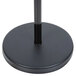 A black round base with a black pole holding a black Aarco hostess sign.