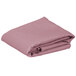 A folded pink rectangular Intedge cloth table cover.