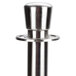 A close-up of a stainless steel metal cap on an Aarco rope style crowd control stanchion.