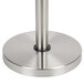 A metal crowd control stanchion with a round metal base.
