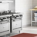 A Garland natural gas range with convection oven on a counter in a professional kitchen.