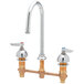 A white deck-mount faucet with two brass lever handles.