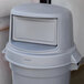 A Continental gray round dome top lid on a trash can.