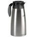 A close-up of a silver stainless steel Curtis coffee server with a black lid.