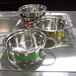 A Bon Chef stainless steel steam table pot with riveted handles on a metal surface.