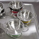 A tray with several stainless steel Bon Chef steam table pots on it.