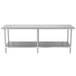 A long silver stainless steel work table with two shelves.