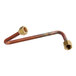 A copper pipe with a brass nut on the end.