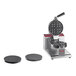 A white Estella commercial waffle maker with waffle and waffle cone plates.