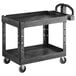 A black Rubbermaid utility cart with two shelves and wheels.