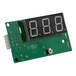 A green circuit board with a black digital display with numbers.