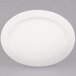 A CAC Garden State bone white porcelain platter with an oval shape and white rim.