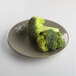A plate of broccoli on a mushroom-colored Elite Global Solutions melamine plate.