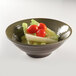 An Elite Global Solutions Lizard-colored melamine bowl filled with lettuce and tomatoes.