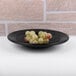 A black melamine pasta/soup bowl with a pebble design on it.