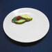A white Elite Global Solutions melamine plate with food on it.