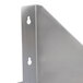 A close-up of a stainless steel wall mount shelf with holes on the side.