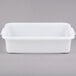A white rectangular Vollrath plastic container with handles.