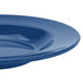 A close-up of a Texas Blue melamine bowl with a rim.