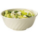 A fluted melamine bowl filled with salad with pears and blue cheese.