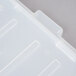 A close-up of a white Vollrath Traex food storage box lid with a line in it.